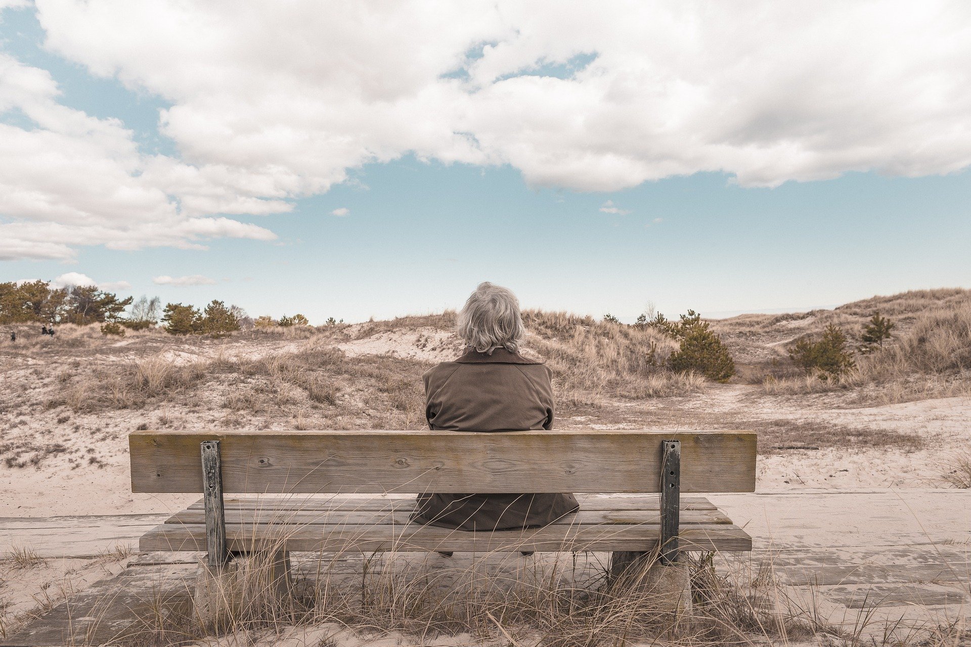 Retired Person Sitting on Bench in Desert