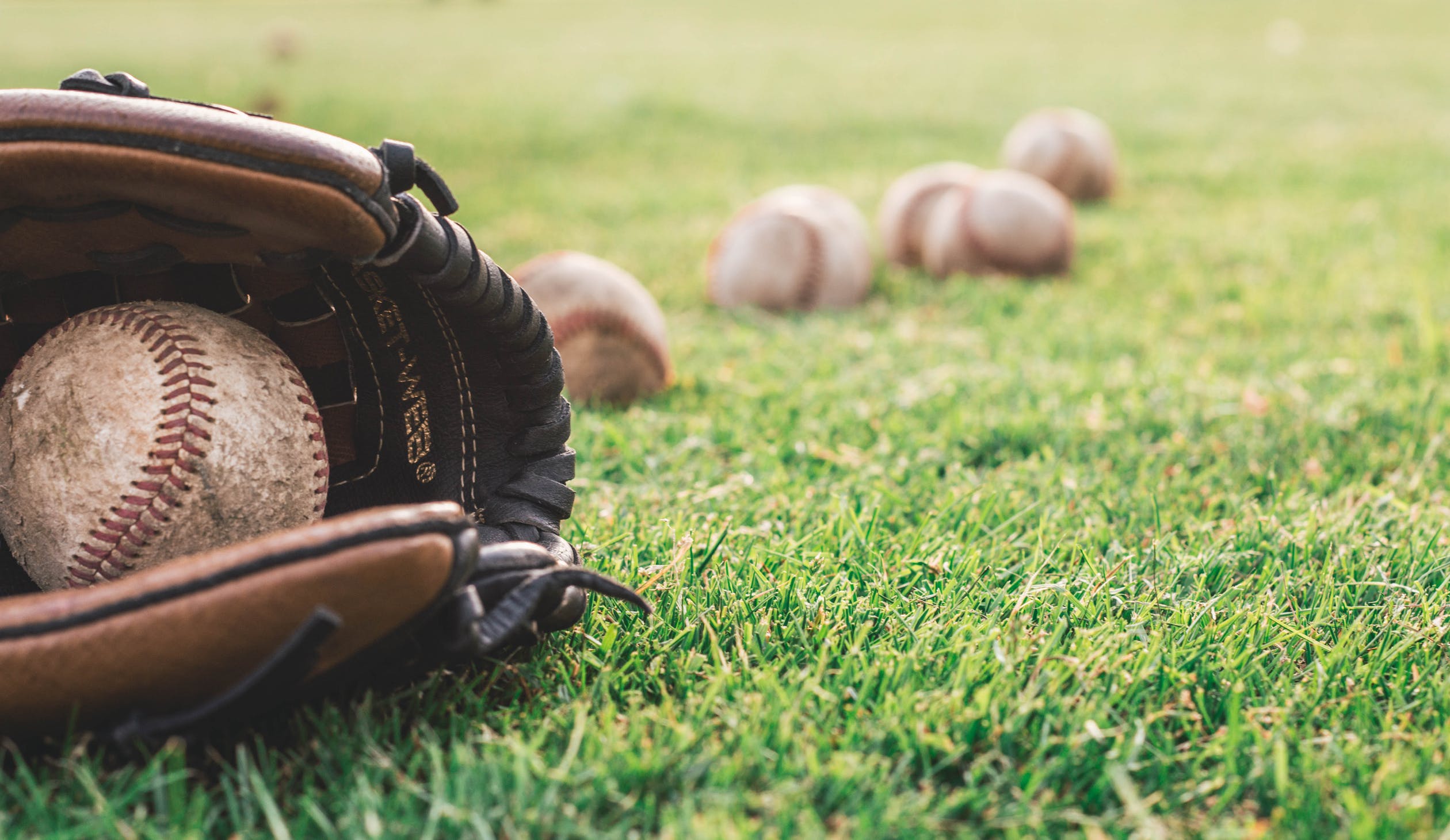 Baseball glove and baseball in field